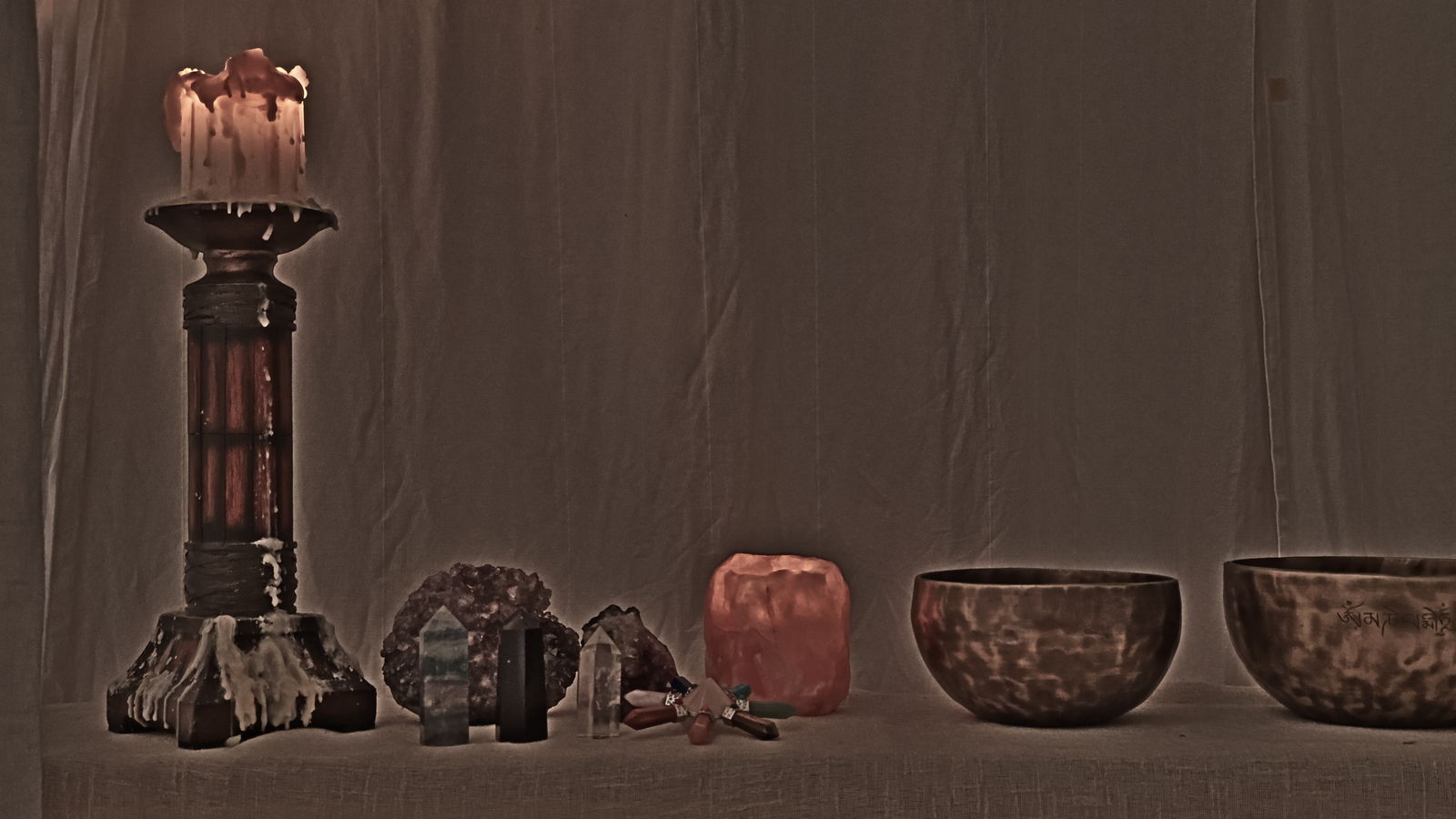 Candle, crystals and Tibetan singing bowls set out before a massage in Gran Canaria