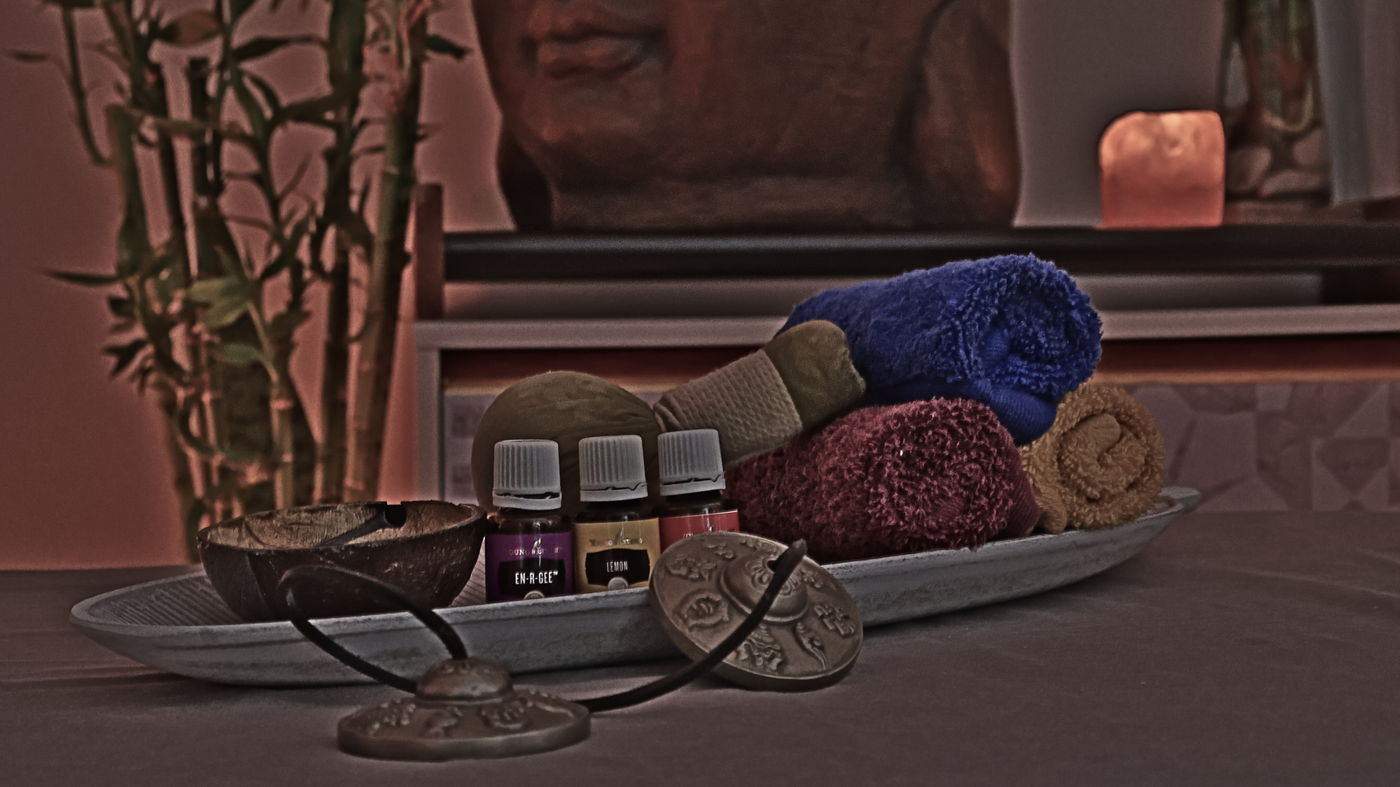 Massage oils, hot compresses and Tibetan tingsha on a tray &mdash; relaxing massage studio in Playa del Ingl&eacute;s, Gran Canaria