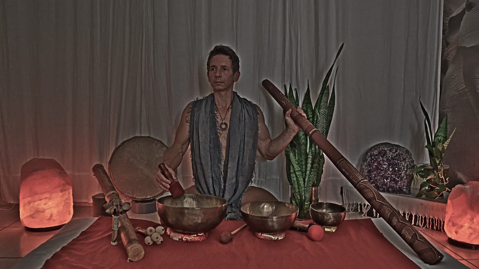 Greg with singing bowls, frame drum and didgeridoo during a sound journey